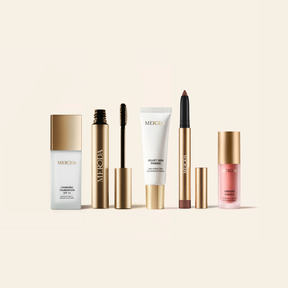 The Full Face Bestseller Set including Changing Foundation, primer, brow gel, shimmer stick and blush in gold packaging.