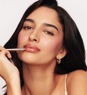 Signature Lip Pencil in Perfect Nude applied by a model to define and shape lips for a seamless matte finish.