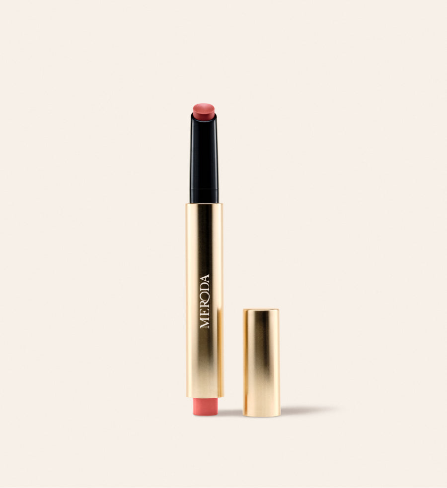 Hydrating Lip Tint in Peachy Rose featuring a sleek gold metallic pen with a detached cap against a neutral background.