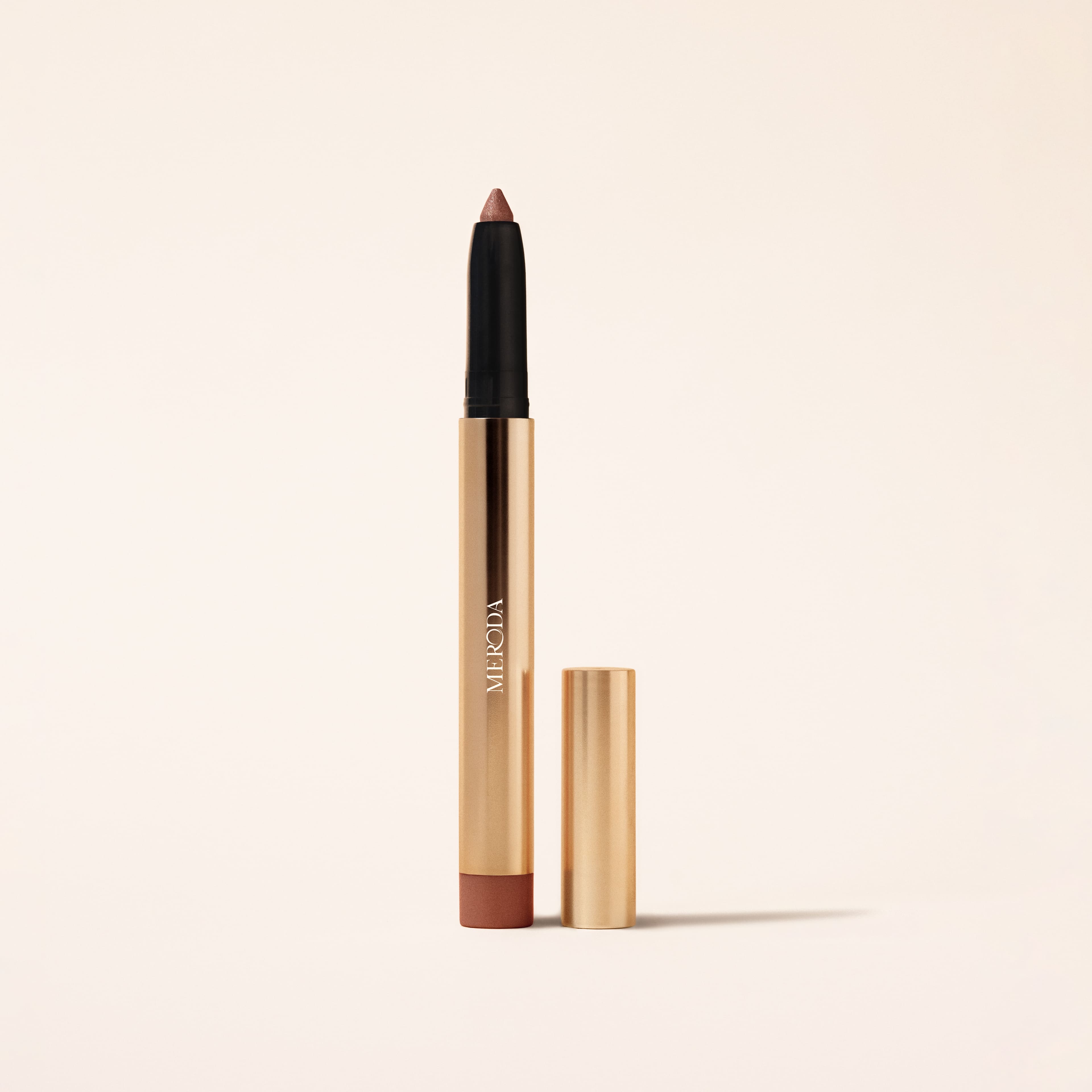 Eye Perfecting Shimmer Stick in Mauve featuring a shimmering tip and sleek gold metallic packaging.