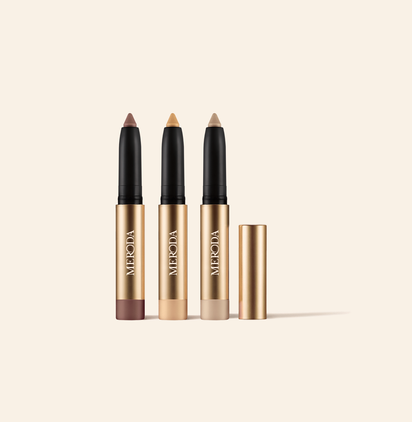Mini Eye Shimmer Set featuring three gold Mini Eye Perfecting Shimmer Sticks in radiant mauve, gold, and pearl shades.