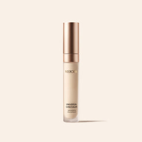 Universal Concealer tube with a rose gold cap and longwear, creaseproof benefits on a neutral background.