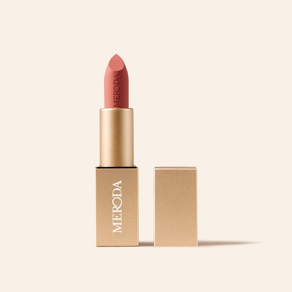 Velvet Dream Lipstick in Pink Peony featuring an embossed matte bullet and sleek square gold case on cream.