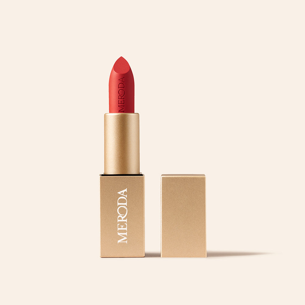 Velvet Dream Lipstick in Luscious Red featuring an embossed matte bullet and square gold case on cream.