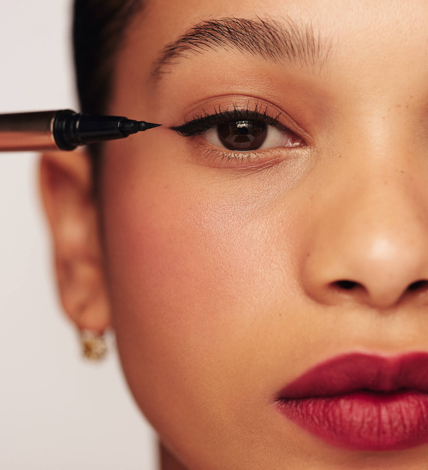 It's All About The Wing Liquid Waterproof Eyeliner application on a model for a sharp, black winged look.