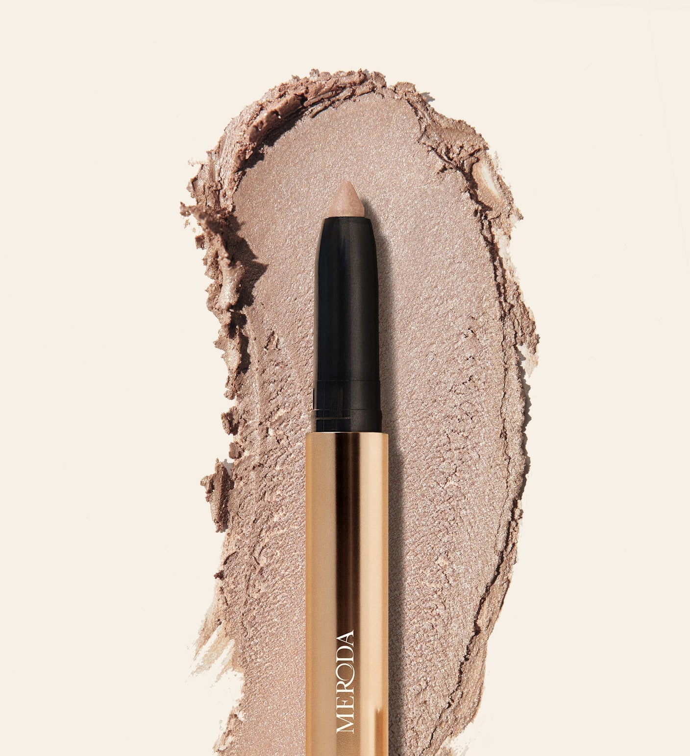 Eye Perfecting Shimmer Stick in Champagne with a luminous cream texture swatch for a radiant finish.