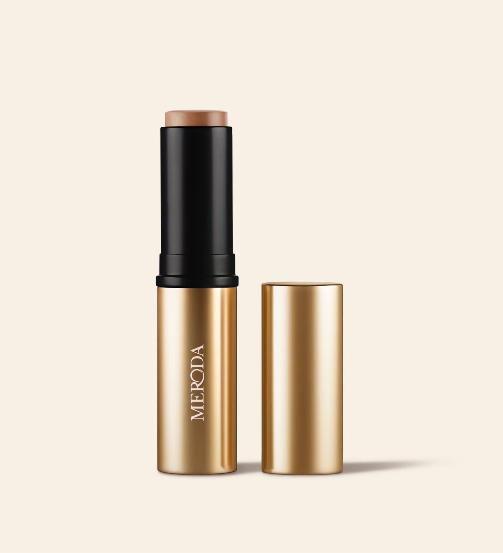 Soft Tan Bronzer in shade Light, featuring gold packaging with cap removed to show the creamy stick formula.