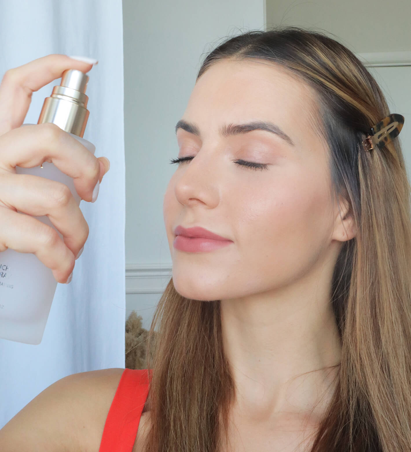 Final Touch Setting Spray mist application on a woman's face to hydrate skin and lock in a radiant makeup finish